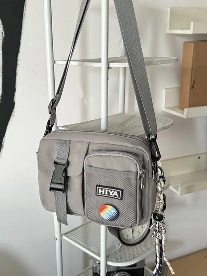 Unisex Casual Plain Color Release Buckle Crossbody Bag with Astronaut Charm, Zipper Crossbody Bag with Random Color Badge, Aesthetic Shoulder Bag, Zippered Sling Bag, Casual Crossbody Bags